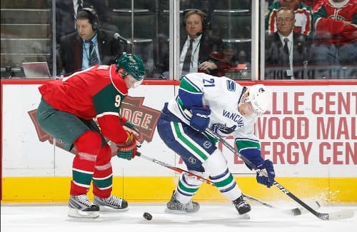SAINT PAUL, MN - OCTOBER 19: Mikko Koivu #9 of the Minnesota Wild knocks the puck away from Mason Raymond #21 of the Vancouver Canucks during the game at the Xcel Energy Center on October 19, 2010 in Saint Paul, Minnesota. (Photo by Bruce Kluckhohn/NHLI via Getty Images)
