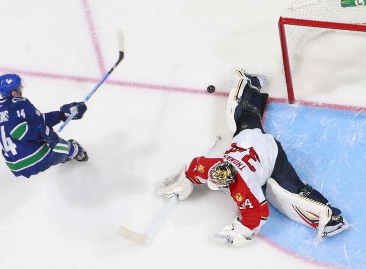 Tim Thomas stops Alex Burrows' shootout attempt en route to a 3-2 win.