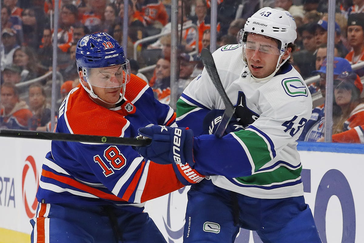 Vancouver Canucks' Quinn Hughes (43) fights for control of the