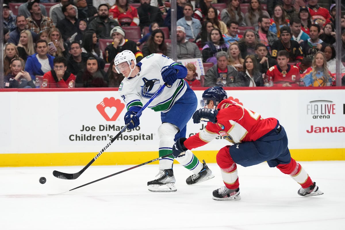 Vancouver Canucks' J.T. Miller wears a pride-themed warmup jersey