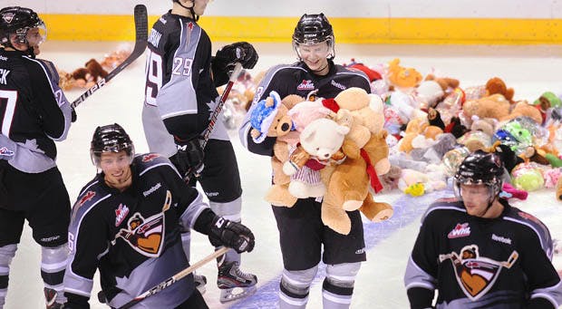 Brett Kulak with an armful of teddy bears at last year's teddy bear toss. This year he leads the Giants in scoring.