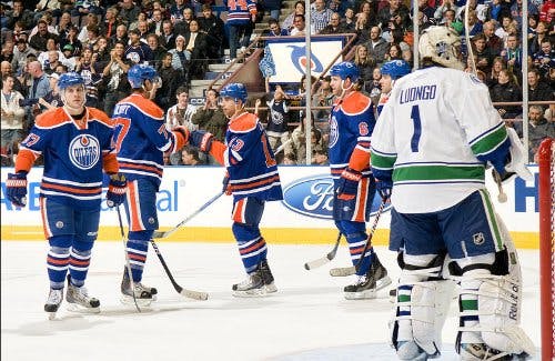 EDMONTON, AB - MARCH 23: Roberto Luongo #1 of the Vancouver Canucks looks on as the Edmonton Oilers celebrate a second-period goal at Rexall Place on March 23, 2010 in Edmonton, Alberta, Canada. (Photo by Andy Devlin/NHLI via Getty Images)