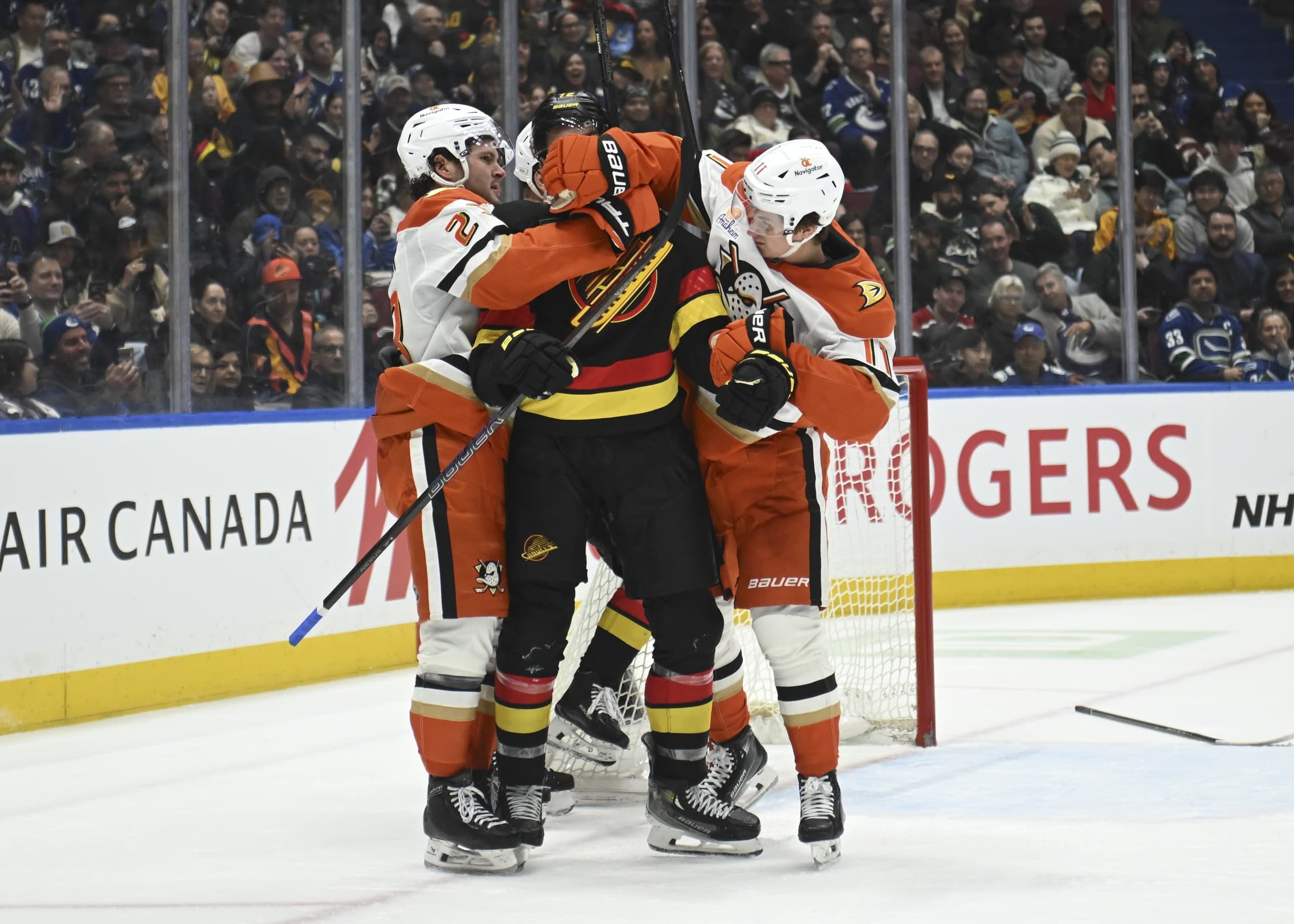 ;Anaheim Ducks forward Mason McTavish (23) and forward Trevor Zegras (11) control Vancouver Canucks forward Filip Chytil (72) during the third period at Rogers Arena.