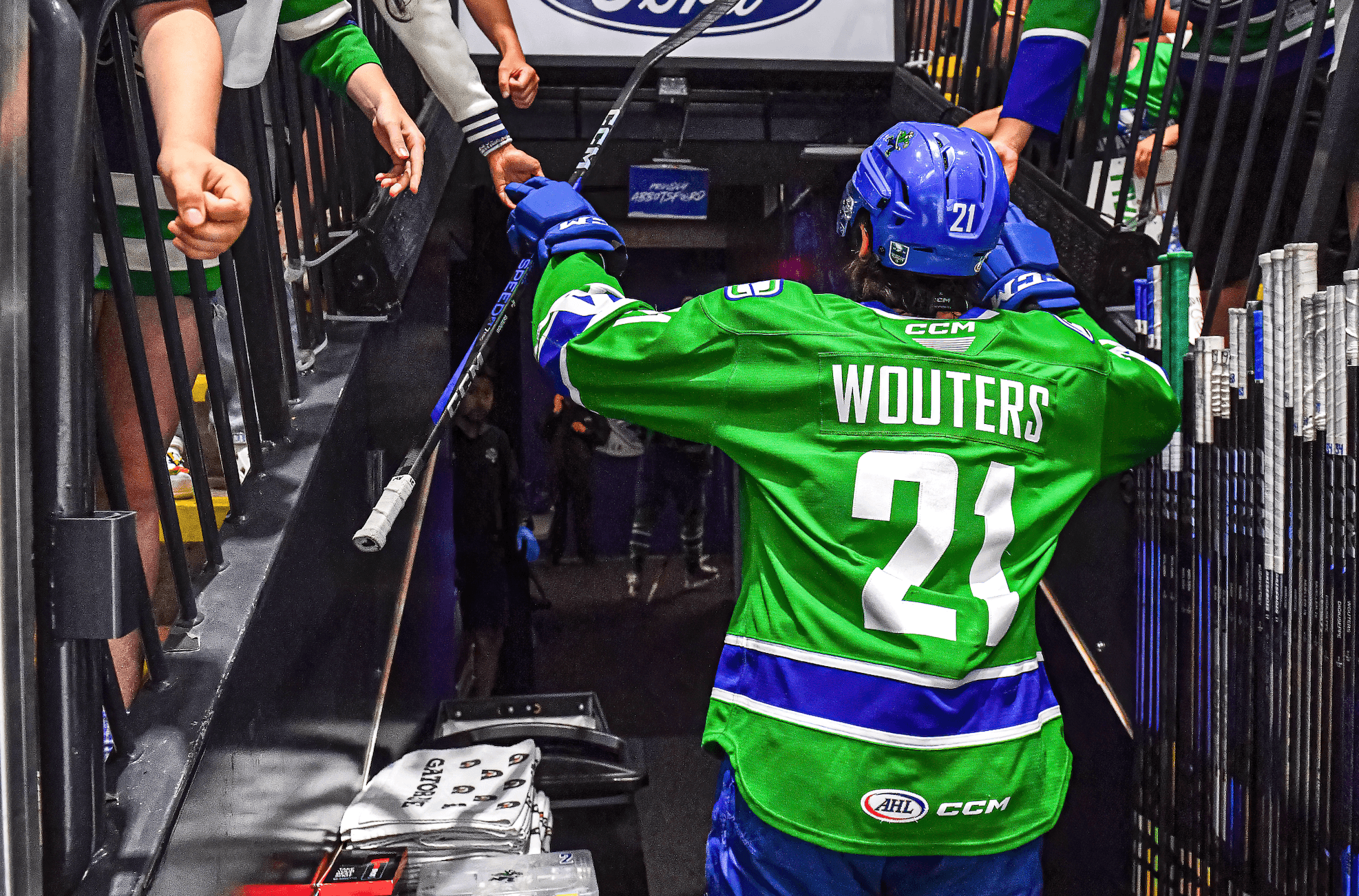Abbotsford Canucks captain Chase Wouters high fives fans as he exits the ice at Abbotsford Centre.