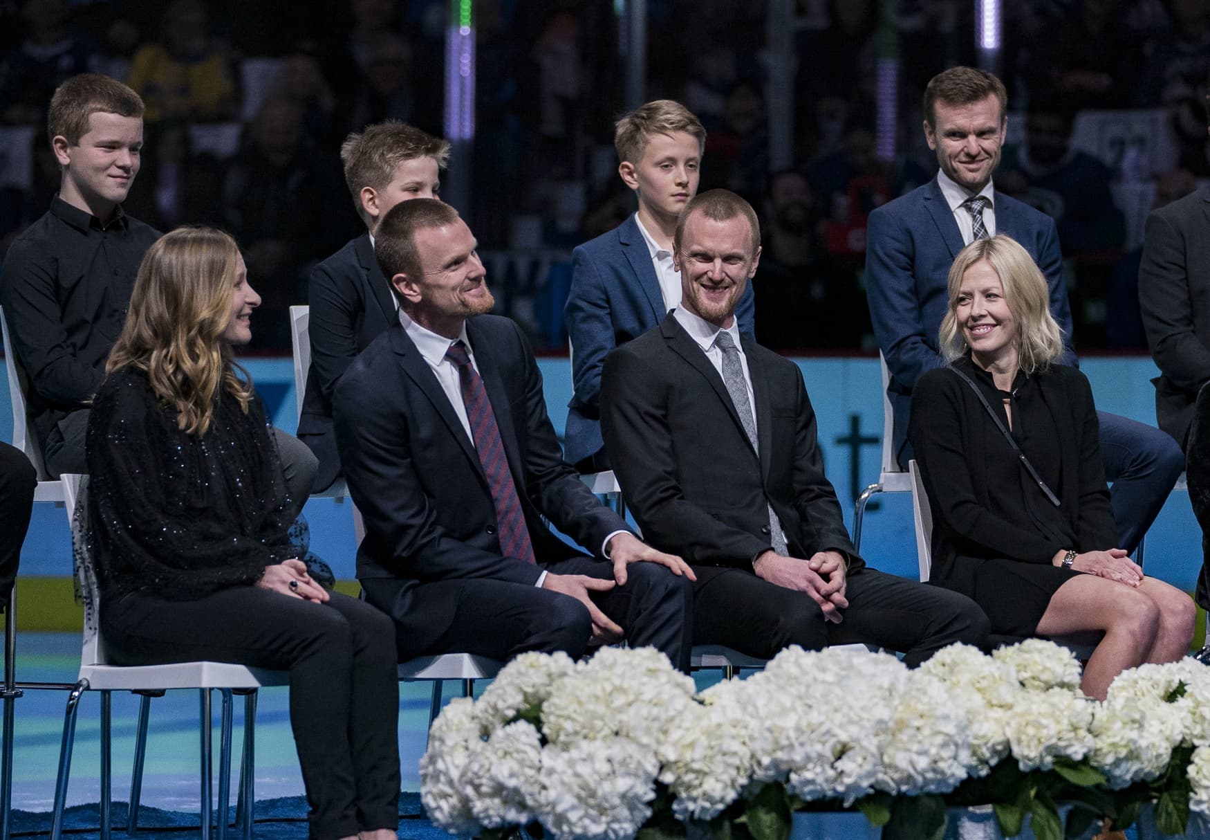 Vancouver Canucks former players Daniel Sedin and Henrik Sedin of Sweden stand with their families during a number retirement ceremony held prior to a game between the Vancouver Canucks and Chicago Blackhawks at Rogers Arena.